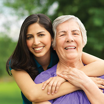 Granddaughter hugging grandmother in a park. Read about Donor-Advised Funds